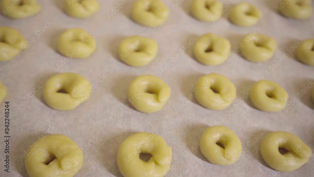rings of raw dough on a baking sheet ready to bake, italian regional bakery rings of raw dough on a baking sheet ready to bake, italian regional bakery