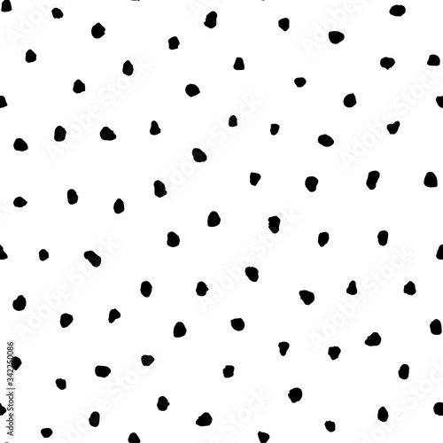 Black grunge irregular polka dots vector seamless pattern on white background.
