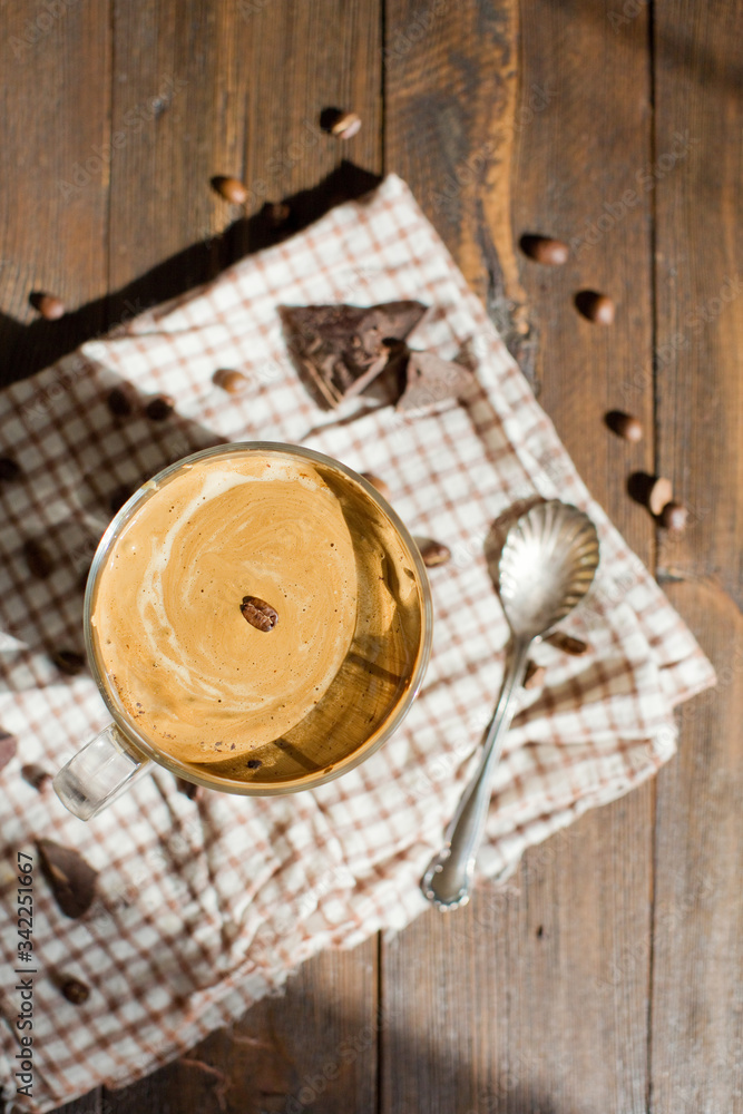 Iced Dalgona Coffee with chocolate powder in a glass cup. Trendy fluffy creamy whipped coffee. Iced Dalgona Coffee with chocolate powder in a glass cup. Trendy fluffy creamy whipped coffee.