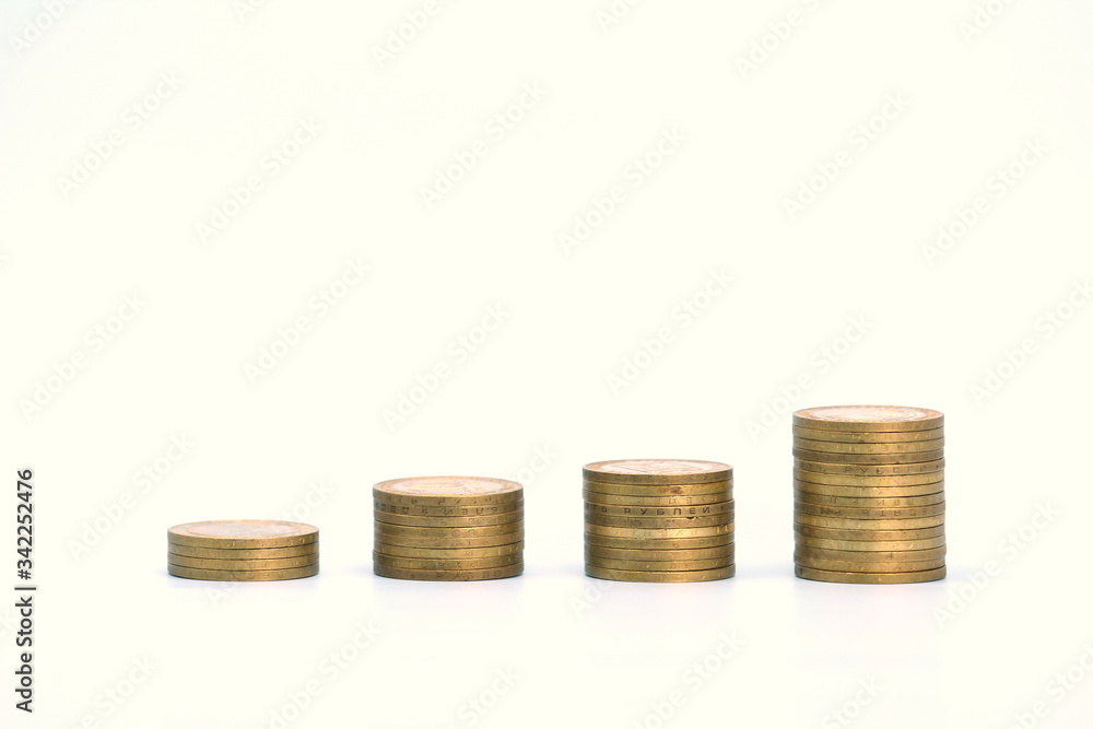 Piles of golden metallic coins. Columns of coins of different heights. The concept of business, economy, finance, investment and prices. Place for text and background for design. Piles of golden metallic coins. Columns of coins of different heights. The concept of business, economy, finance, investment and prices. Place for text and background for design.