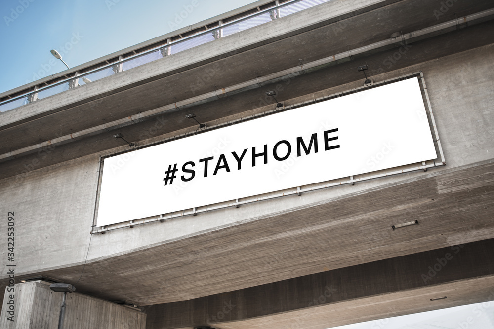 quarantine, caution and epidemic concept - big white billboard with stay home hashtag on concrete bridge quarantine, caution and epidemic concept - big white billboard with stay home hashtag on concrete bridge