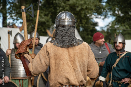 Medieval role-playing historical games. Men dressed in costumes of medieval knights. Armed with swords, axes and wooden shields.