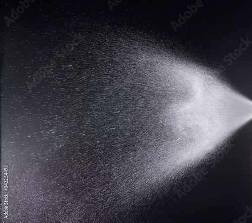 a spray of liquid in a black background.