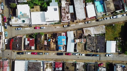 Aerial, top down, drone shot above volunteers rebuilding a roof of a house, Hurricane aftermath, in the Cayey town, sunny day, in Puerto Rico, USA photo