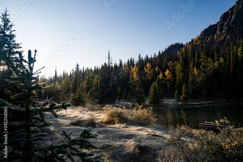 a frosty autumn day at dawn by a lake in the Rocky Mountains
