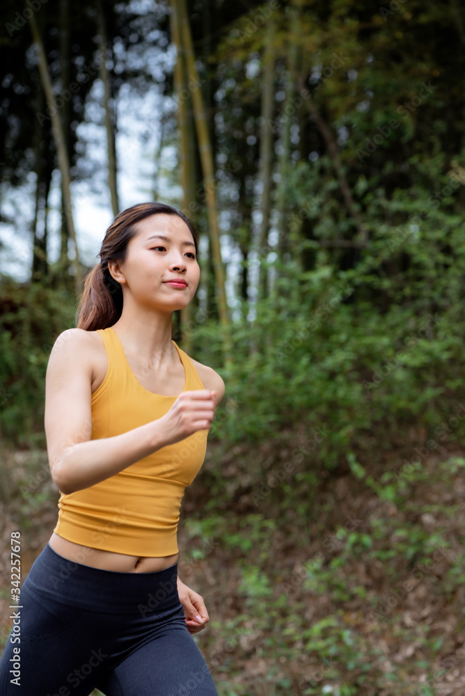 A young Asian female running outdoors