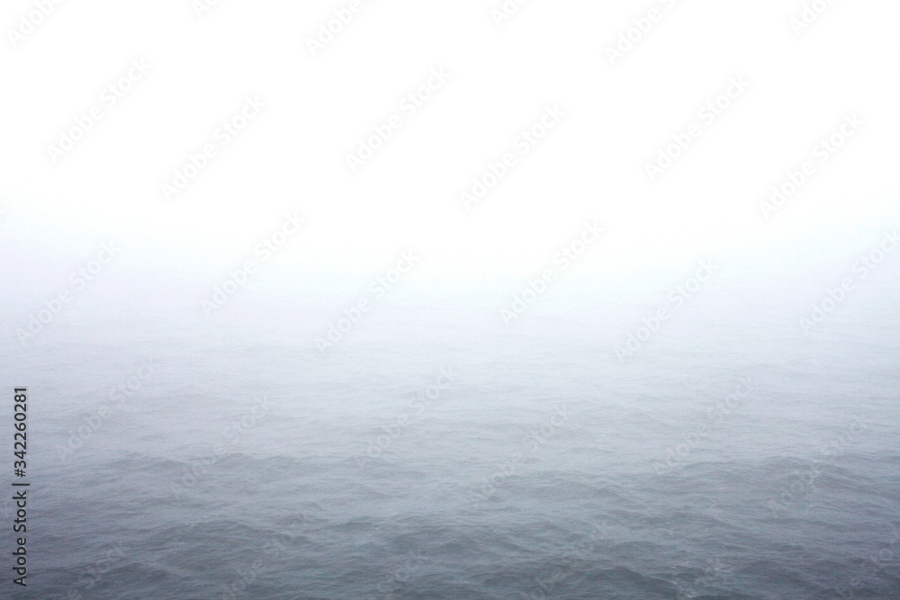 Idyllic View Of Sea Against Sky During Foggy Weather - obrazy, fototapety, plakaty 