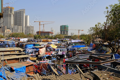 MUMBAI, INDIA - February 7, 2019: Dhobi Ghat open air laundry next to Mahalaxmi station, the largest of its kind in the world, © leochen66