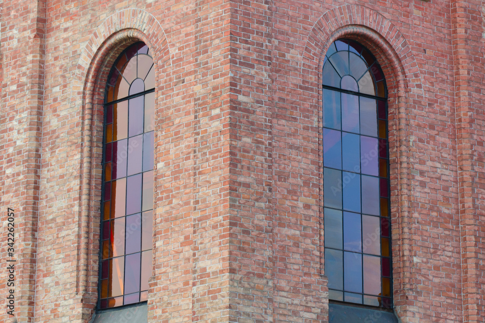 Wall of an old castle with large windows with stained glass windows. Wall of an old castle with large windows with stained glass windows.