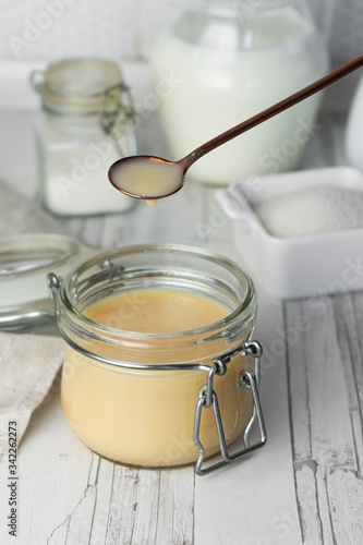 freshly prepared home-made condensed milk, on a light background
