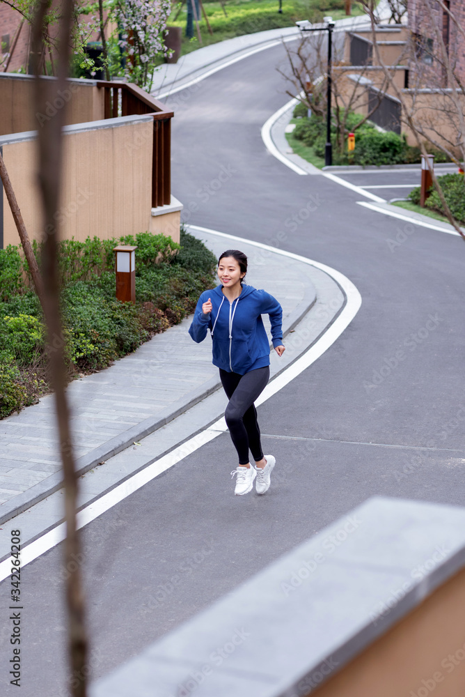 A young Asian female running outdoors