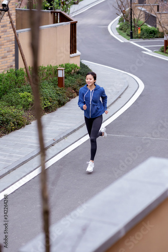 A young Asian female running outdoors