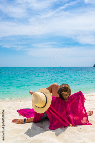 Young woman on the white sand beach