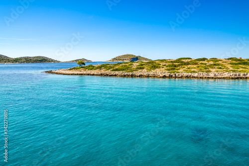 Beautiful lagoon with turquoise water of sea. Mediterranean scenery with blue sky  sea and island. Croatia  vacation travel concept.
