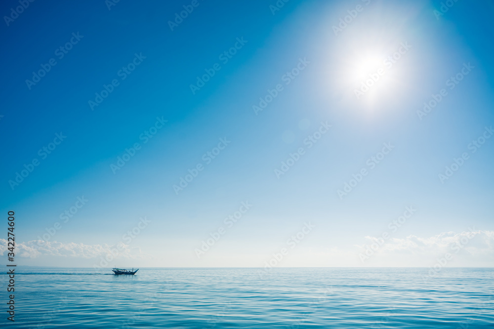 Boat sailing in the sun through the Arabigo Sea in the direction of Masirah Island, Oman