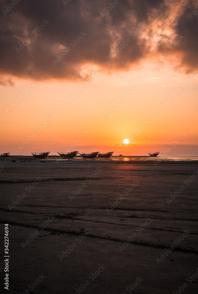 Boats stranded at sunset on Masirah Island, Oman
