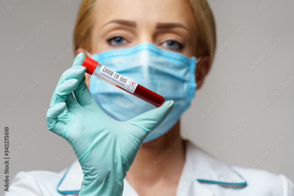 medical doctor nurse woman wearing protective mask and gloves - holding virus blood test medical doctor nurse woman wearing protective mask and gloves - holding virus blood test