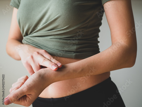 Wallpaper Mural Slim Woman measures pulse. People, sport, fitness and health concept. Close-up Torontodigital.ca
