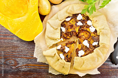 Valokuva Pie with pumpkin and onions on dark board top