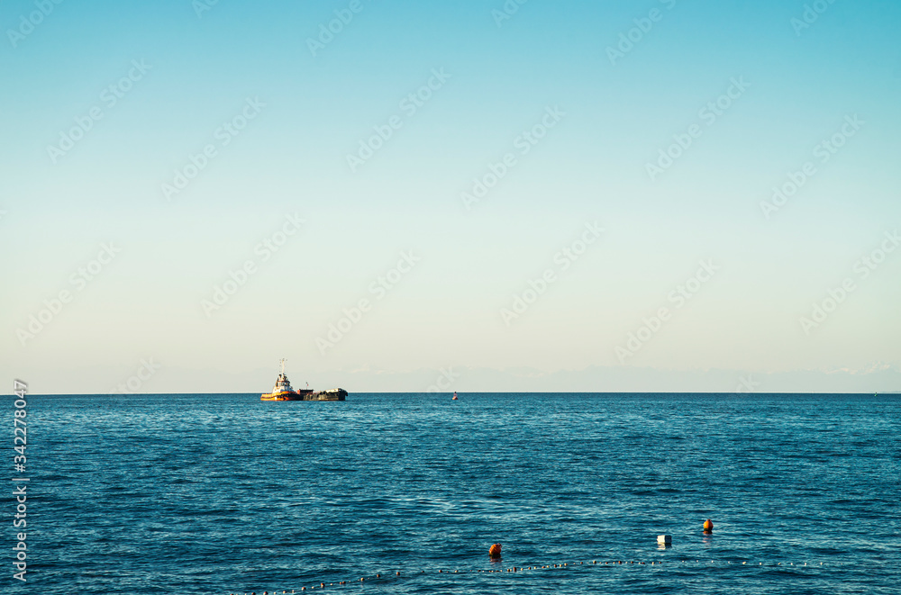 Tugboat is pushing another vessel on the sea