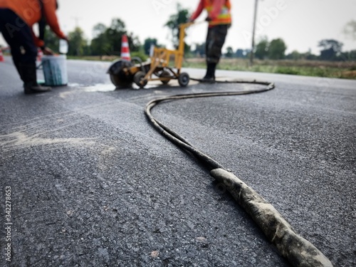 Workers using machines Cut asphalt pavement For road surface repair (blur images)