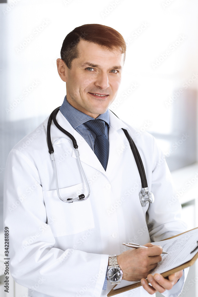 Doctor man using clipboard for filling up medication history records. Perfect medical service in clinic. Physician at work in hospital. Medicine and healthcare concepts Doctor man using clipboard for filling up medication history records. Perfect medical service in clinic. Physician at work in hospital. Medicine and healthcare concepts