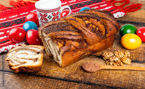 Traditional Romanian Easter table with cozonac and pasca meaning Sweetbread and Matzo an unleavened flatbread that is part of Jewish cuisine and forms an integral element of the Passover. Happy Easter photo