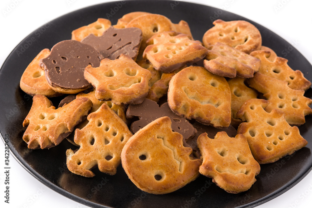 Halloween cookies on black plate isolated on white background. Close up