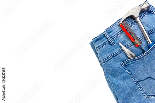 Jeans, screwdriver, hammer and pliers on white background. Jeans texture, Blue denim jeans with tools. Copy space concept