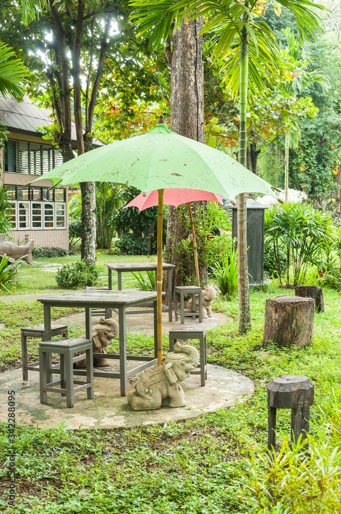 Table and green umbrella in the garden