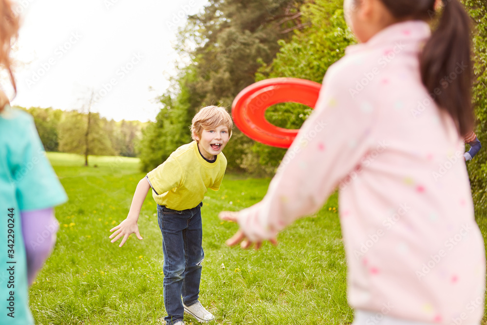 Group of kids in frisbee playing in the park Stock Photo | Adobe Stock