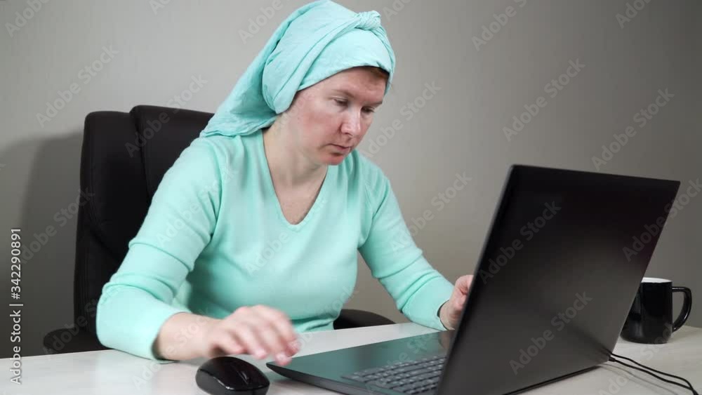 Freelancer in headscarf working from home and using laptop Freelancer in headscarf working from home and using laptop