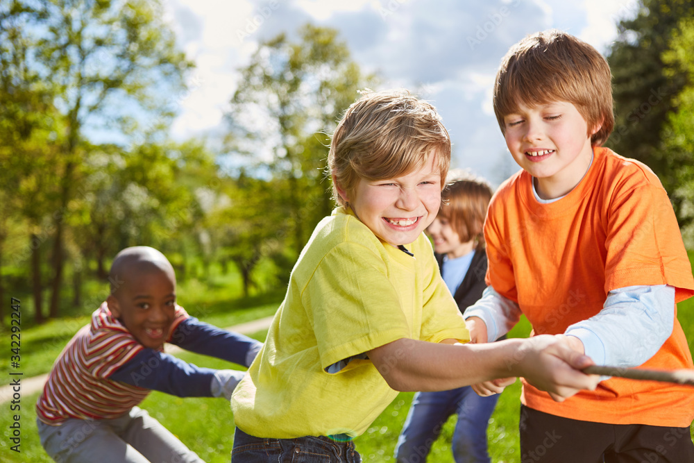 Fototapeta premium Kids team has fun in tug of war competition