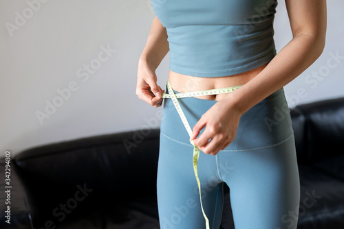 A young Asian woman exercising indoors