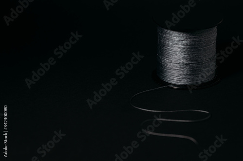 Thread on a bobbin on a black background