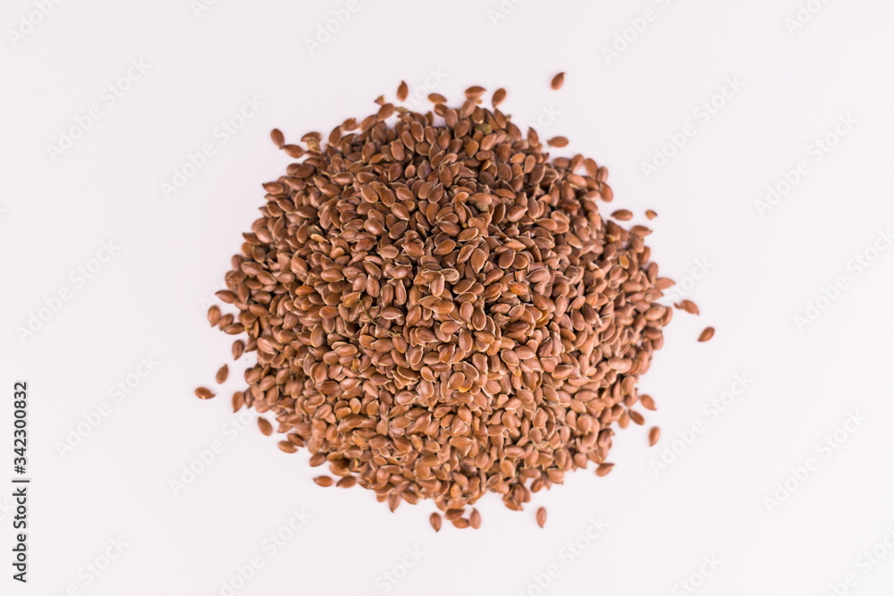A handful of flax seeds on a white background. Top view. A handful of flax seeds on a white background. Top view.