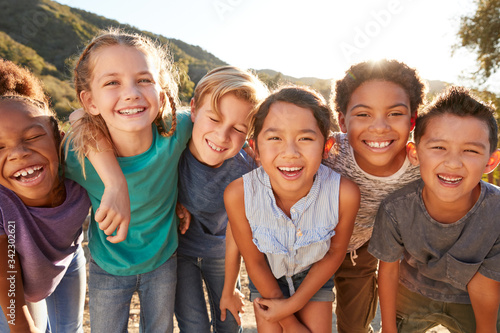 Portrait Of Multi-Cultural Children Hanging Out With Friends In Countryside Together photo