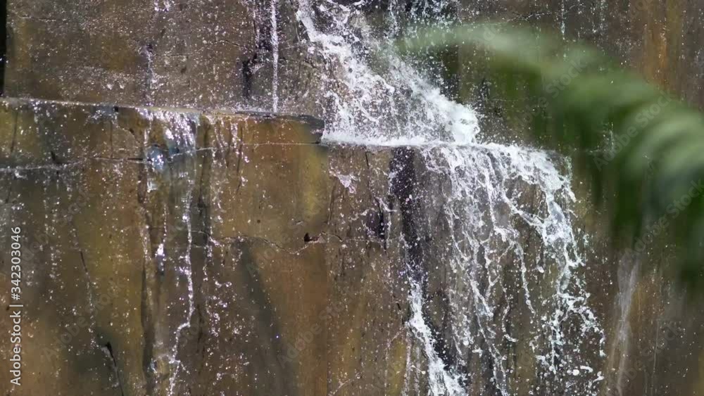 Water falling down from a stone wall in 4k slow motion 60fps Water falling down from a stone wall in 4k slow motion 60fps