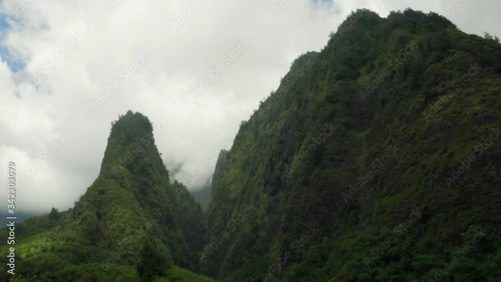 Epic timelapse of light and dark clouds billowing over the needle spire Iao Valley State Park, Maui, Hawaii. Epic timelapse of light and dark clouds billowing over the needle spire Iao Valley State Park, Maui, Hawaii.