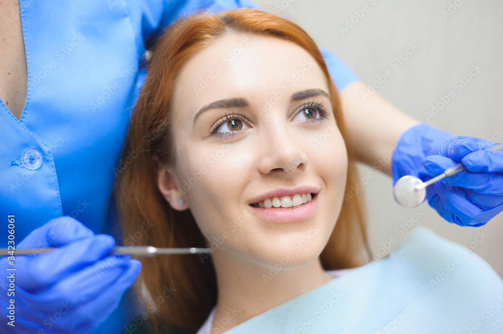 Dentist examining a patient's teeth in the dentist. Dentist examining a patient's teeth in the dentist.