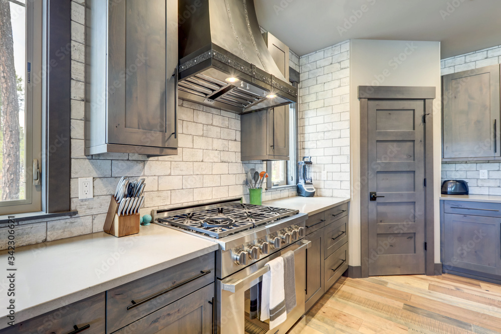 Absolutly stunning kitchen interior with grey tone of brown muted natural tones with light hardwood. Absolutly stunning kitchen interior with grey tone of brown muted natural tones with light hardwood.