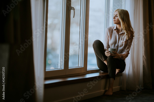 Young woman with cup of tea...