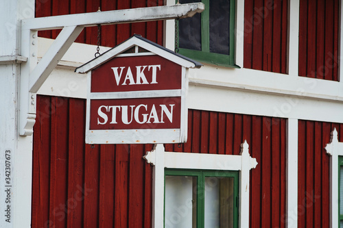 Red wooden house with white frames. Old house. Vakt stugan photo