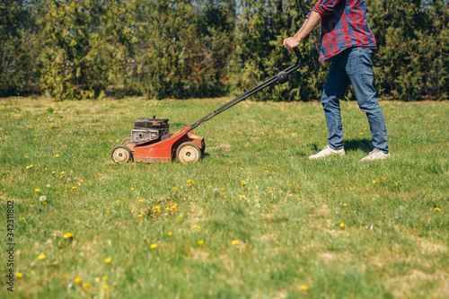 man using lawn mower outdoor