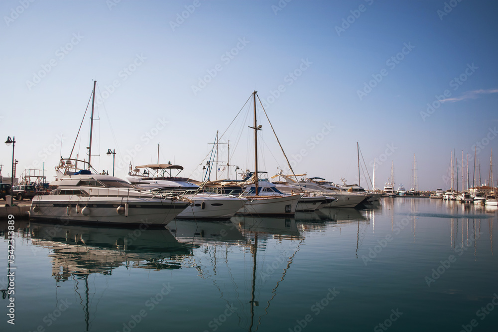 Luxury white yachts against the blue sky in the harbor of the port of Limassol Marina, Cyprus.