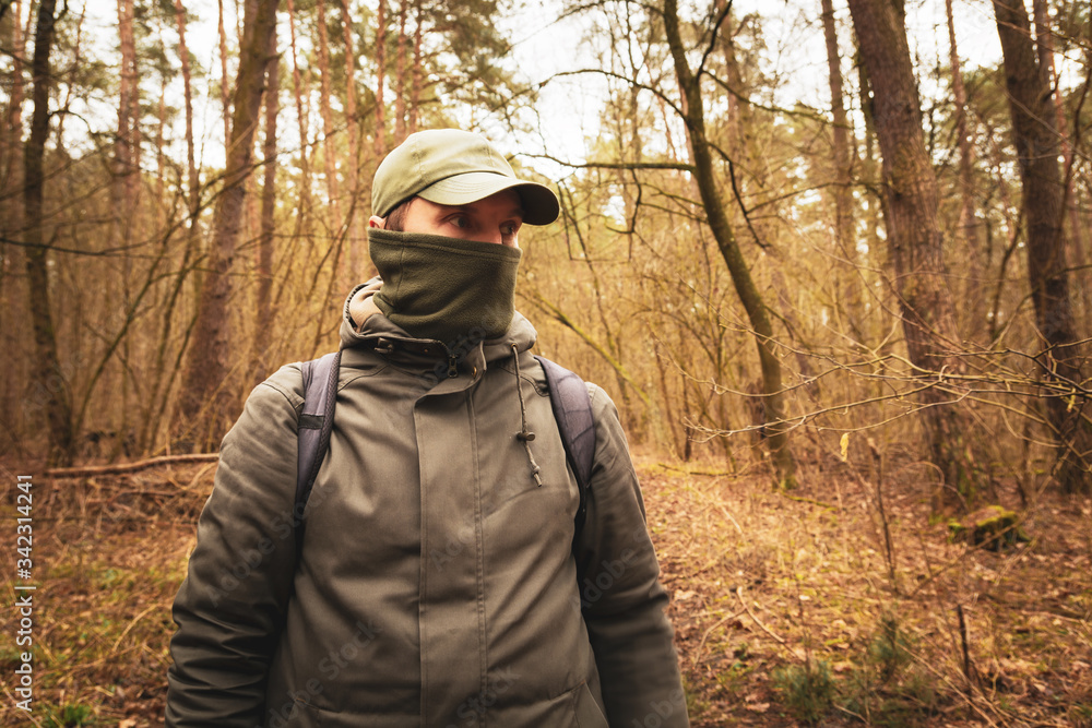 A man with a covered face in the woods A man with a covered face in the woods