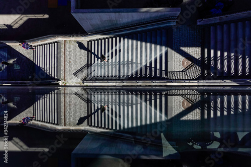 Photography Stockholm, Sweden  Pedestrians on a staircase on Kvarnholmen are reflected in a glass wall