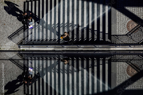 Canvas Print Stockholm, Sweden  Pedestrians on a staircase on Kvarnholmen are reflected in a glass wall