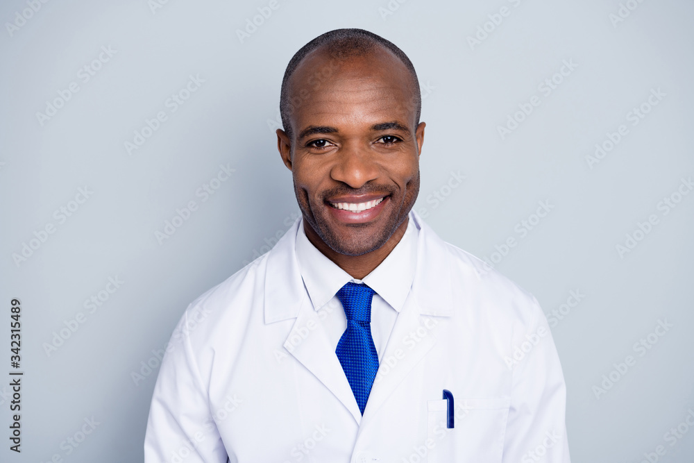 Photo of doctor intern handsome dark skin guy good mood friendly smiling to patients virologist testing deadly disease wear white lab coat blue neck tie isolated grey color background Photo of doctor intern handsome dark skin guy good mood friendly smiling to patients virologist testing deadly disease wear white lab coat blue neck tie isolated grey color background