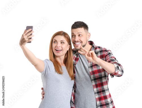Couple taking selfie on whi...